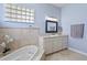 Spa-like bathroom with soaking tub and updated vanity at 5155 Lake Deeson Woods Ct, Lakeland, FL 33805