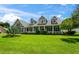 Two-story house with a wrap-around porch and landscaped lawn at 5155 Lake Deeson Woods Ct, Lakeland, FL 33805