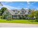 Two-story house with a wrap-around porch and landscaped lawn at 5155 Lake Deeson Woods Ct, Lakeland, FL 33805