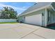 Two-car garage with a concrete driveway at 5155 Lake Deeson Woods Ct, Lakeland, FL 33805