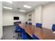 Modern meeting room with large table and TV at 150 E Robinson St # 1907, Orlando, FL 32801