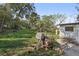 Large backyard with mature trees and grill at 4410 Rossmore Dr, Orlando, FL 32810