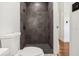 Modern bathroom with dark tile shower and toilet at 4410 Rossmore Dr, Orlando, FL 32810