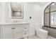 Bright bathroom boasts a white vanity, updated fixtures, and a large mirror at 4410 Rossmore Dr, Orlando, FL 32810