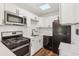 Bright kitchen with stainless steel appliances and white shaker cabinets at 4410 Rossmore Dr, Orlando, FL 32810