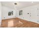 Bright living room with hardwood floors, neutral walls, and a modern chandelier at 4410 Rossmore Dr, Orlando, FL 32810