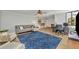 Living room with a comfy couch, a blue rug, and a workspace at 530 E Central Blvd # 201, Orlando, FL 32801