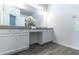 Modern bathroom with a double sink vanity, quartz countertop, and ample storage space and vanity lighting at 992 Jetway St, Orange City, FL 32763