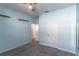 A bright, airy bedroom with light blue walls, gray carpet, and a ceiling fan at 992 Jetway St, Orange City, FL 32763