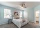 Inviting bedroom with light blue walls, a ceiling fan, and a comfortable bed with stylish bedside tables at 992 Jetway St, Orange City, FL 32763