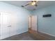 Light blue bedroom featuring gray carpet and white closet doors at 992 Jetway St, Orange City, FL 32763