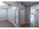 Bright hallway featuring wood-look tile flooring leading to an office space at 992 Jetway St, Orange City, FL 32763