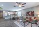 Spacious living room with an open floor plan connected to dining and kitchen areas, wood-look floors, and modern decor at 992 Jetway St, Orange City, FL 32763