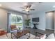 Well-lit living room showcasing wood-look floors, modern furniture, and a sliding door to the backyard at 992 Jetway St, Orange City, FL 32763