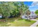 Large white house with a spacious yard at 216 N Saint Clair Abrams Ave, Tavares, FL 32778