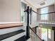 Upstairs hallway with hardwood floors and a view of the staircase at 216 N Saint Clair Abrams Ave, Tavares, FL 32778