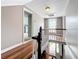 Upstairs hallway with hardwood floors and a view of the staircase at 216 N Saint Clair Abrams Ave, Tavares, FL 32778