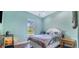 Bright bedroom with a queen bed and wood flooring at 6344 Old Lake Wilson Rd, Davenport, FL 33896