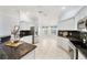 Well-lit kitchen featuring white cabinetry, stainless steel appliances, granite countertops, and tiled floors at 16950 Se 80Th Bellavista Cir, The Villages, FL 32162