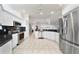 Contemporary kitchen with stainless steel appliances, tile floor, white cabinets, and lots of counter space at 16950 Se 80Th Bellavista Cir, The Villages, FL 32162