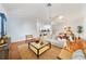 Spacious living room featuring hardwood floors, a ceiling fan, and an open layout with access to other rooms at 16950 Se 80Th Bellavista Cir, The Villages, FL 32162