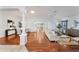 Bright living room featuring hardwood floors, a ceiling fan, and an open layout with access to other rooms at 16950 Se 80Th Bellavista Cir, The Villages, FL 32162