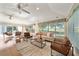 Bright and airy living room featuring large windows, comfortable seating, and hardwood floors at 16950 Se 80Th Bellavista Cir, The Villages, FL 32162