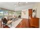 Comfortable living room with hardwood floors, neutral paint, modern decor, and bright light at 16950 Se 80Th Bellavista Cir, The Villages, FL 32162