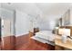 Spacious main bedroom featuring hardwood floors, a ceiling fan, and neutral paint at 16950 Se 80Th Bellavista Cir, The Villages, FL 32162