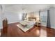 Spacious main bedroom with hardwood floors, neutral colors, and plenty of natural light from large windows at 16950 Se 80Th Bellavista Cir, The Villages, FL 32162