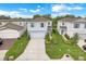 Charming two-story home boasts a well-manicured lawn, two-car garage, and inviting curb appeal at 1001 Rivers Crossing St, Clermont, FL 34714