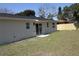 Large backyard with a sliding glass door entrance and a new wooden fence at 511 Reed Ne Ave, Oviedo, FL 32765