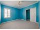 Blue bedroom with ceiling fan and walk-in closet at 8162 Via Bella Notte, Orlando, FL 32836