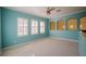 Light teal bedroom with multiple windows, ceiling fan, and neutral carpet at 8162 Via Bella Notte, Orlando, FL 32836