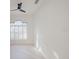 Bright bedroom with white walls, ceiling fan, and plantation shutters at 8162 Via Bella Notte, Orlando, FL 32836