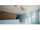 Open bonus room featuring blue walls, a ceiling fan, and plantation shutters at 8162 Via Bella Notte, Orlando, FL 32836