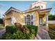 Two-story house with yellow exterior, landscaped yard, and brick driveway at 8162 Via Bella Notte, Orlando, FL 32836