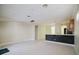 Kitchen with dark countertop island and light colored cabinetry at 8162 Via Bella Notte, Orlando, FL 32836