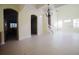 Bright and open-concept living area featuring a staircase, tiled floors, and transom windows at 8162 Via Bella Notte, Orlando, FL 32836