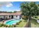 Relaxing backyard with a sparkling pool, patio area, and mature trees at 104 E Berkshire Cir, Longwood, FL 32779