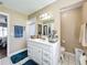 Bathroom with white vanity, toilet, and teal rug at 104 E Berkshire Cir, Longwood, FL 32779