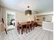 Dining room with a wooden table and chairs, open to the living room and kitchen at 104 E Berkshire Cir, Longwood, FL 32779
