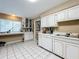 White kitchen with an L-shaped design and a breakfast bar at 104 E Berkshire Cir, Longwood, FL 32779