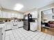 Kitchen with white cabinets, stainless steel appliances, and tile flooring at 104 E Berkshire Cir, Longwood, FL 32779