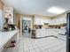 Bright kitchen features white cabinets and ample counter space at 104 E Berkshire Cir, Longwood, FL 32779