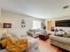 Living room with neutral colored sofas, coffee table and hardwood floors at 104 E Berkshire Cir, Longwood, FL 32779