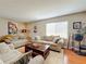 Spacious living room with neutral colored couches and a wood coffee table at 104 E Berkshire Cir, Longwood, FL 32779