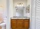 Bathroom featuring a vanity with a granite countertop, wood cabinets, and a toilet at 1624 Rivers Edge Dr, Orlando, FL 32825