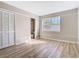 Cozy bedroom with wood floors and natural light, complemented by a closet and attached bathroom at 1624 Rivers Edge Dr, Orlando, FL 32825