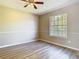 Bright bedroom with wood floors and large window overlooking yard at 1624 Rivers Edge Dr, Orlando, FL 32825